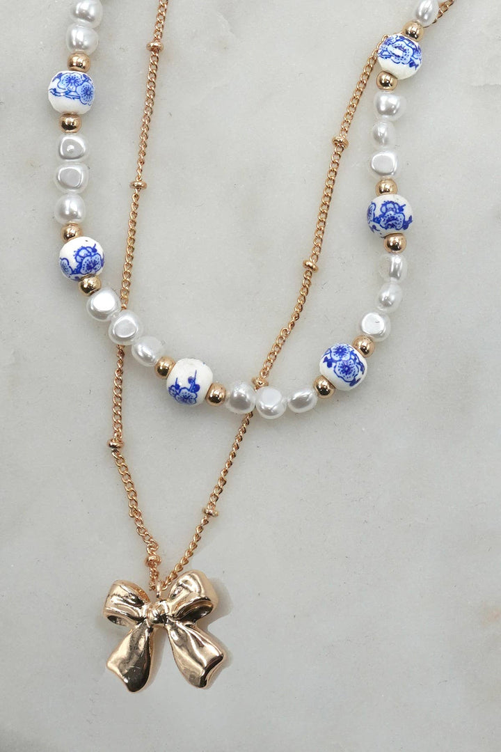 CERAMIC PORCELAIN PEARL BOW LAYER NECKLACE | 80N91555-JOSSLYN by wall to wall-Market Street Nest, Fashionable Clothing, Shoes and Home Décor Located in Mabank, TX